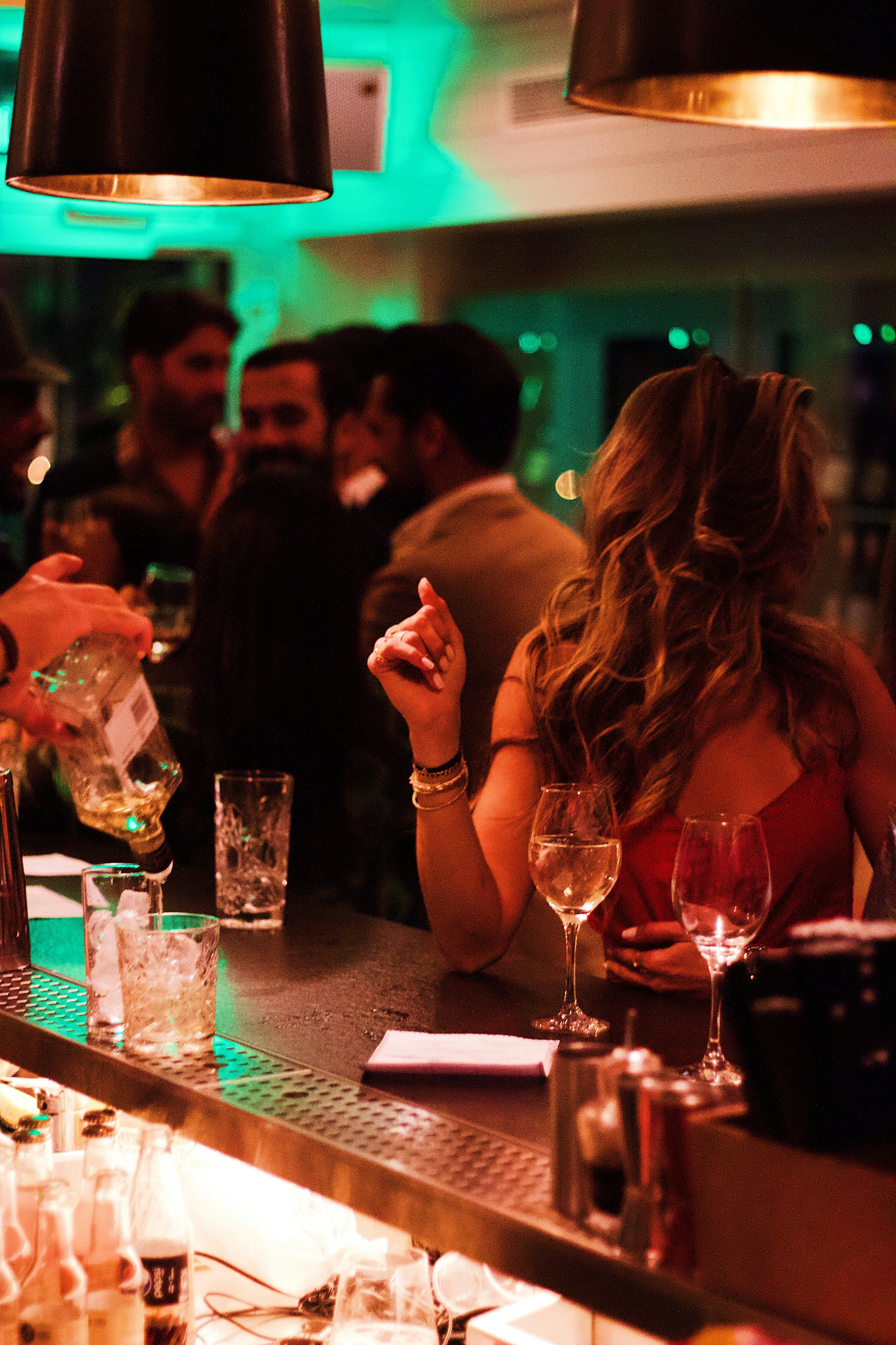 A bartender preparing cocktails at a busy counter